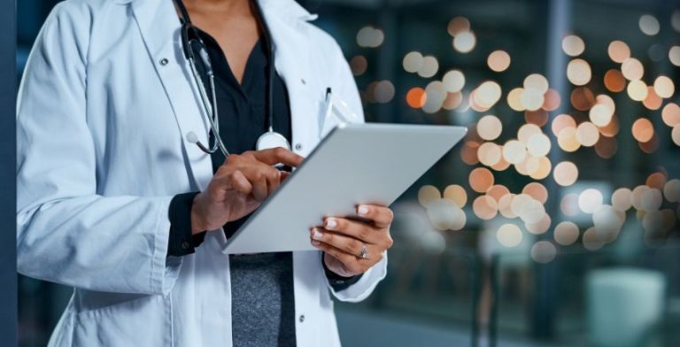 A doctor looking at a clipboard
